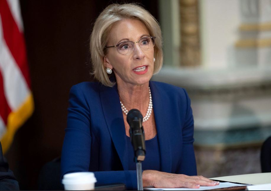Why are Betsy and Dick DeVos so interested in Racine, Wisconsin?